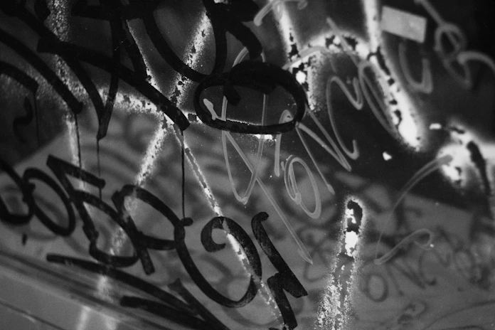 A close-up of Kende’s layered graffiti calligraphy on a wooden panel.