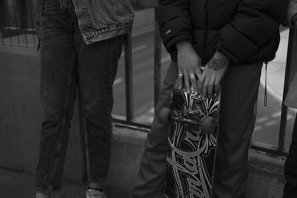 grayscale photo of man in black jacket and pants