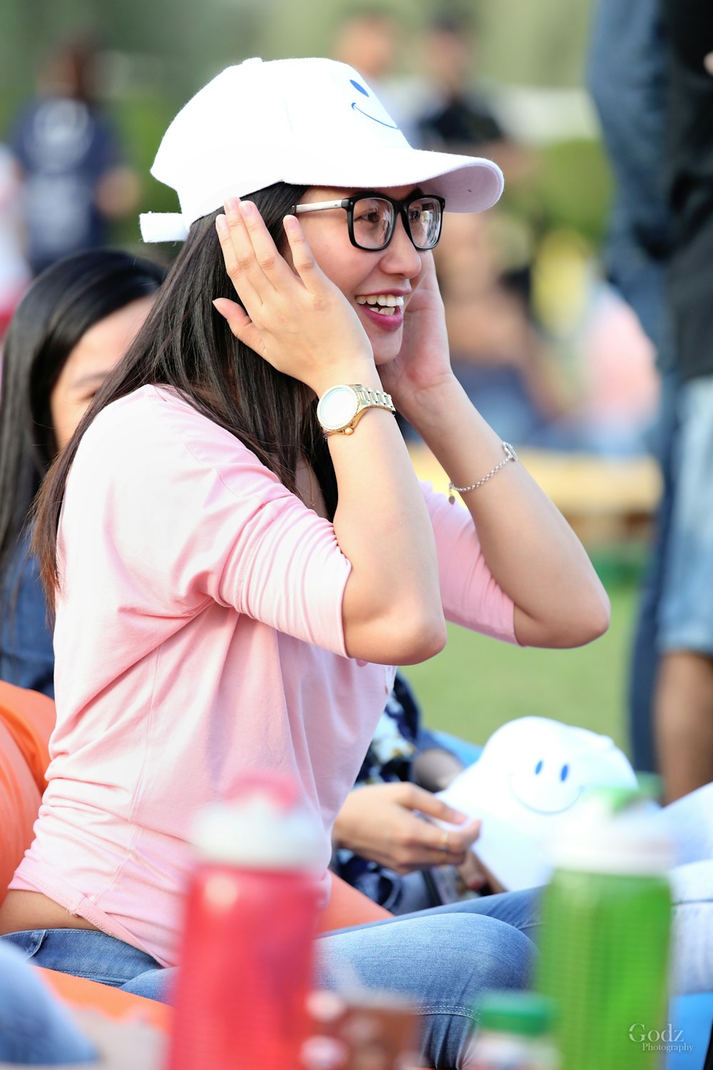 woman in pink shirt wearing black sunglasses