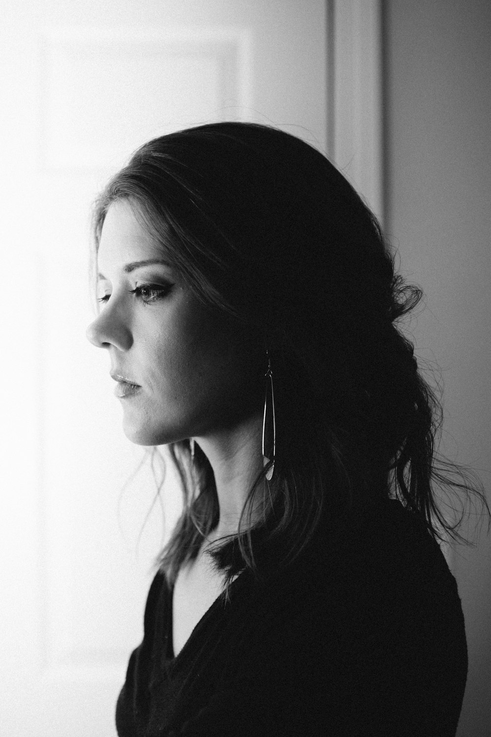 woman in black shirt with white earbuds