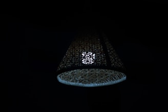 An intricate bamboo lamp casting a soft glow.