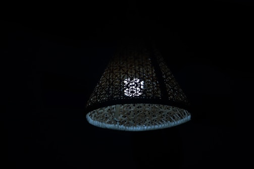 An intricate bamboo lamp casting a soft glow.