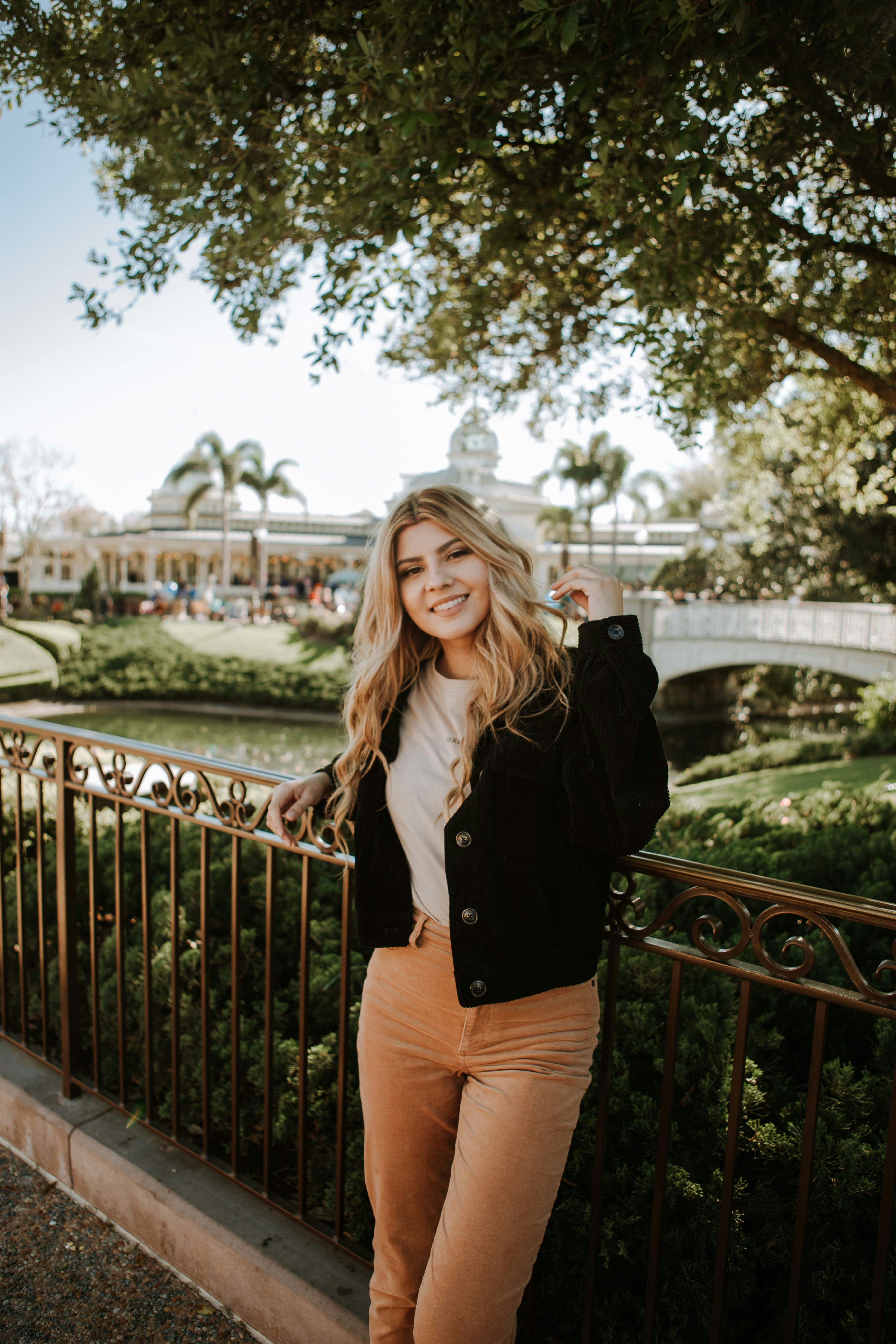 great photo recipe,how to photograph woman in black jacket and brown pants standing on bridge during daytime