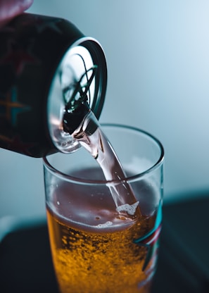 clear shot glass with brown liquid