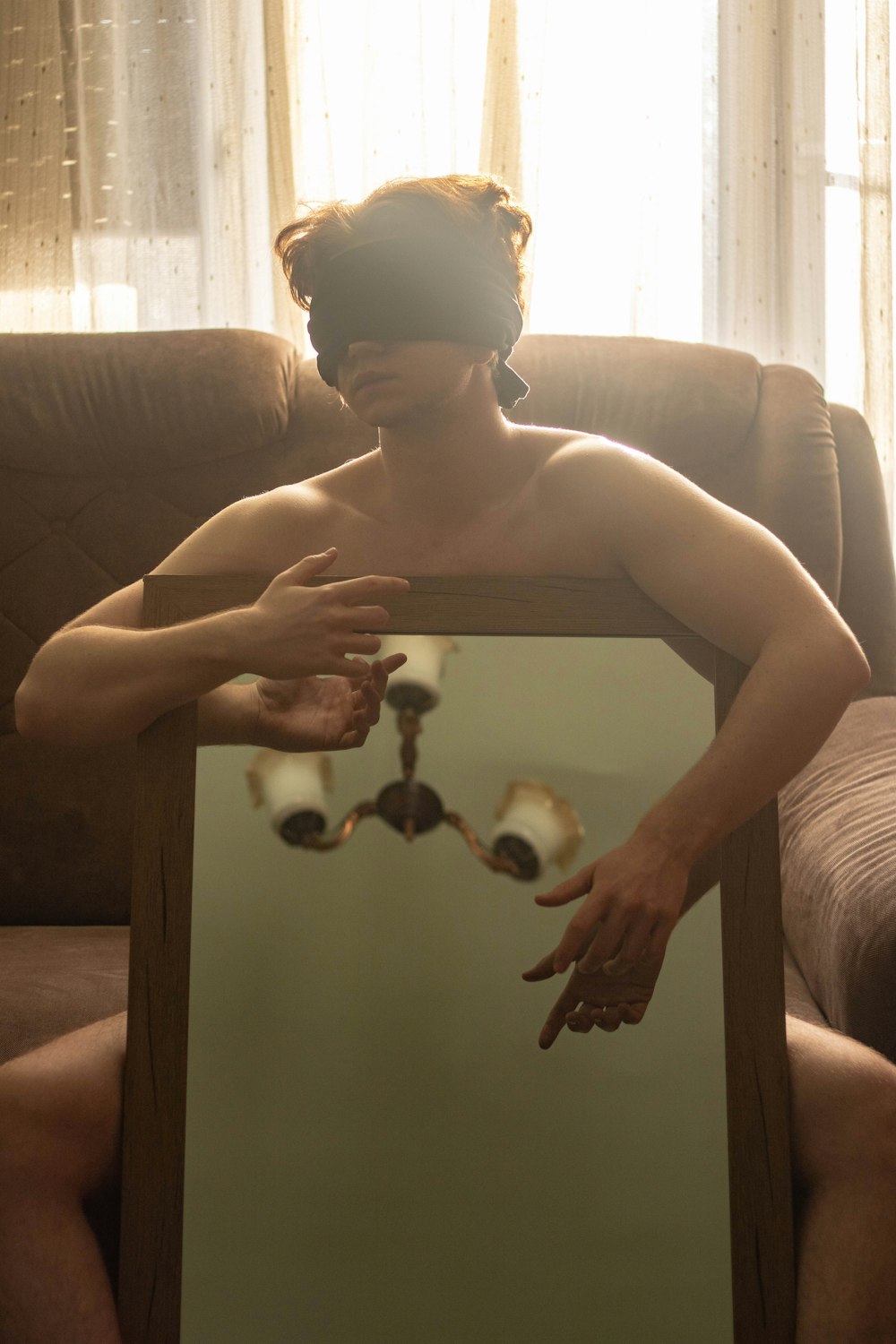 topless boy sitting on couch