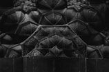 Intricate geometric patterns are formed by a series of interconnected shapes, creating a three-dimensional effect with complex textures and details.
