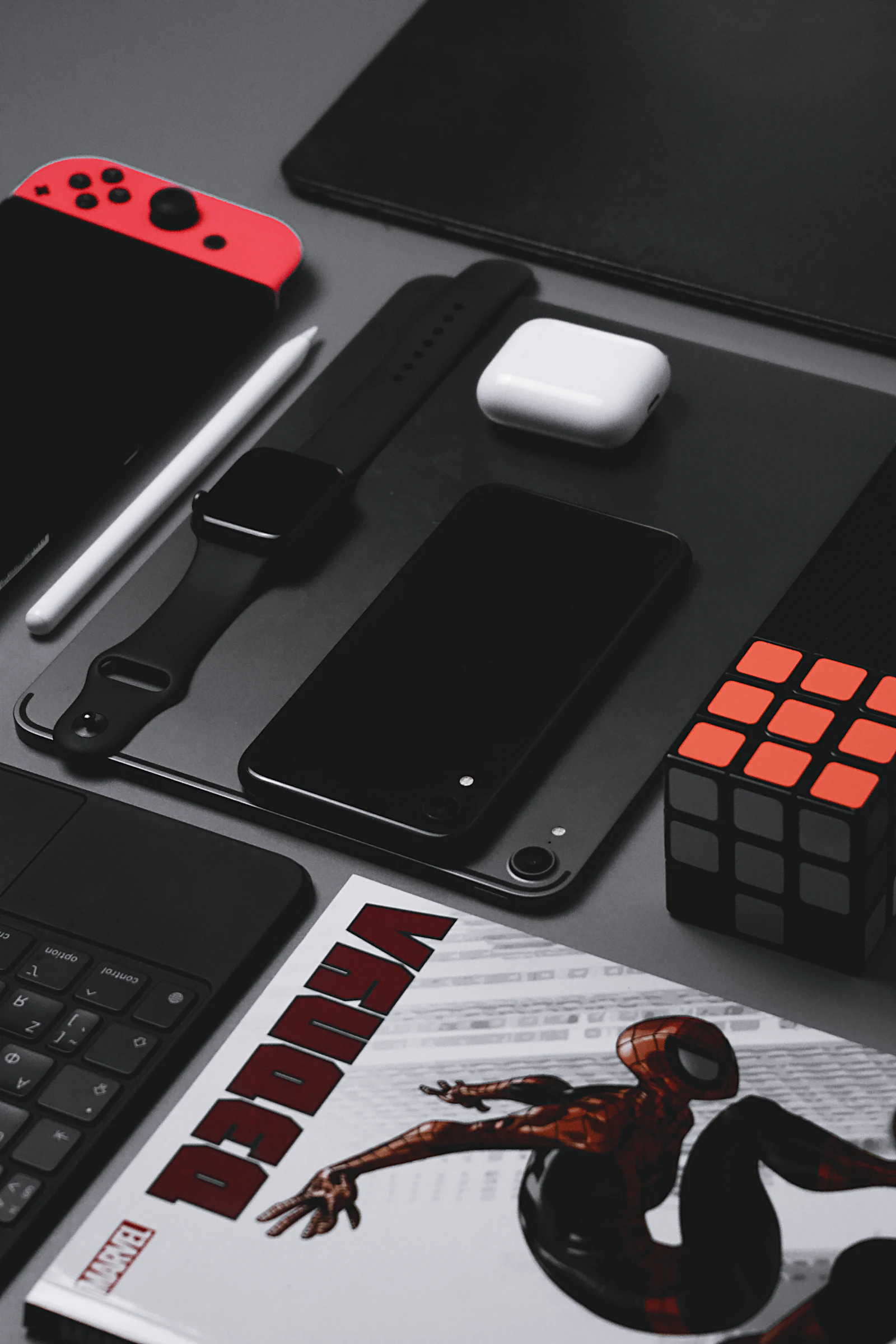 A black iPhone next to a pair of scissors on a table