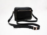 black sling bag on white table
