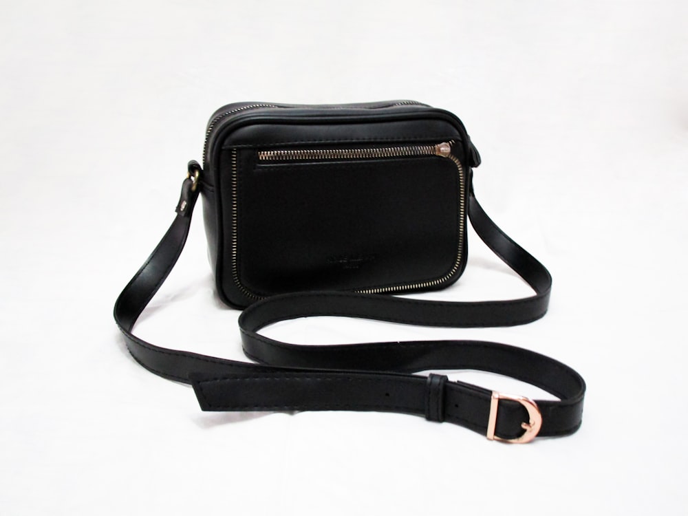 black sling bag on white table