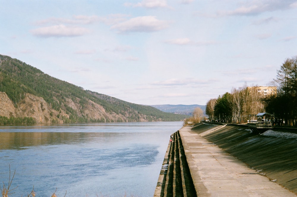 brown wooden dock on lake during daytime