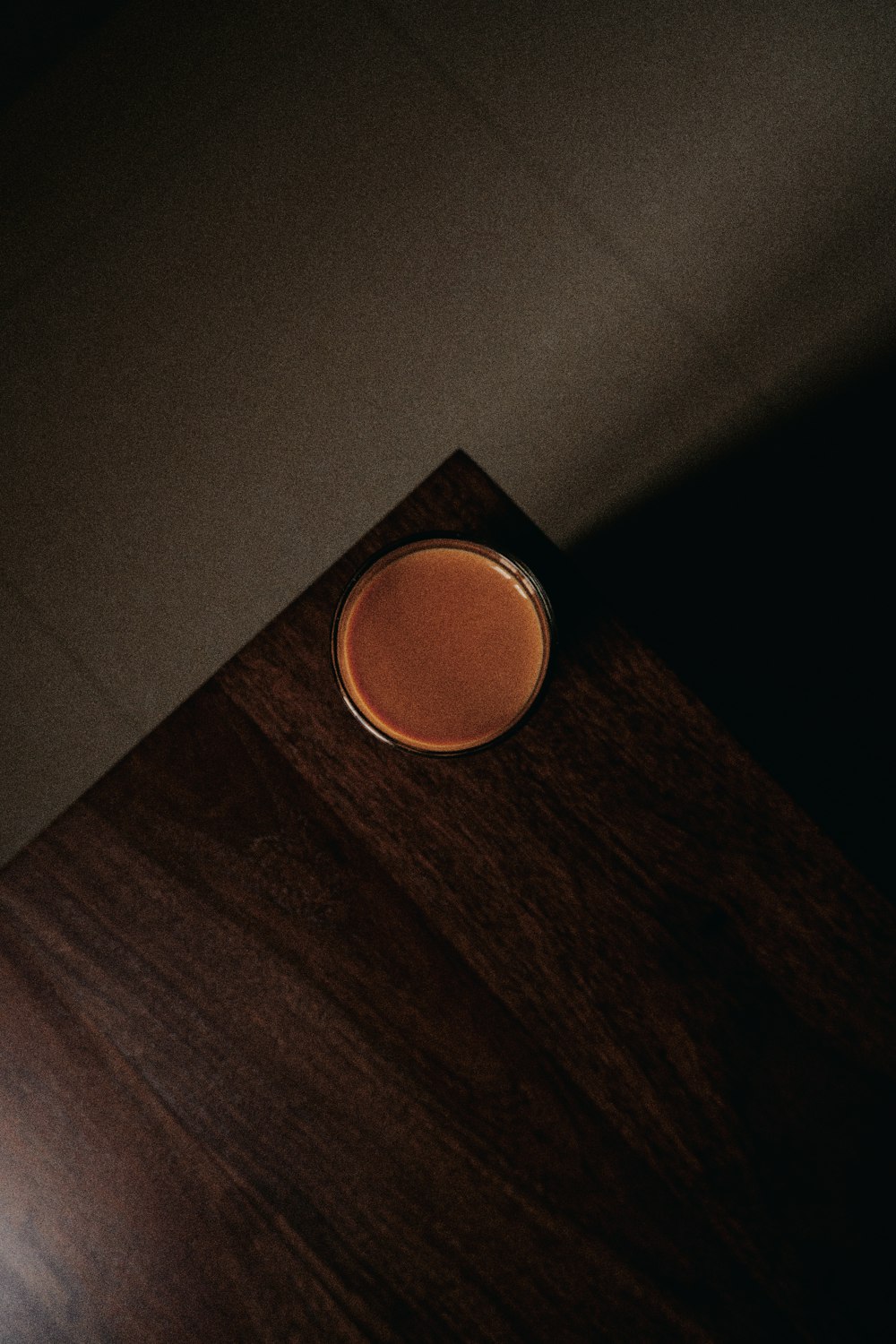 orange round plastic on brown wooden table