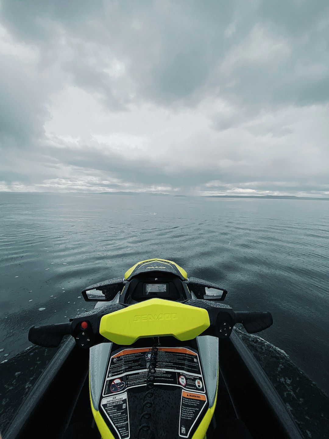 yellow and black sports car on water