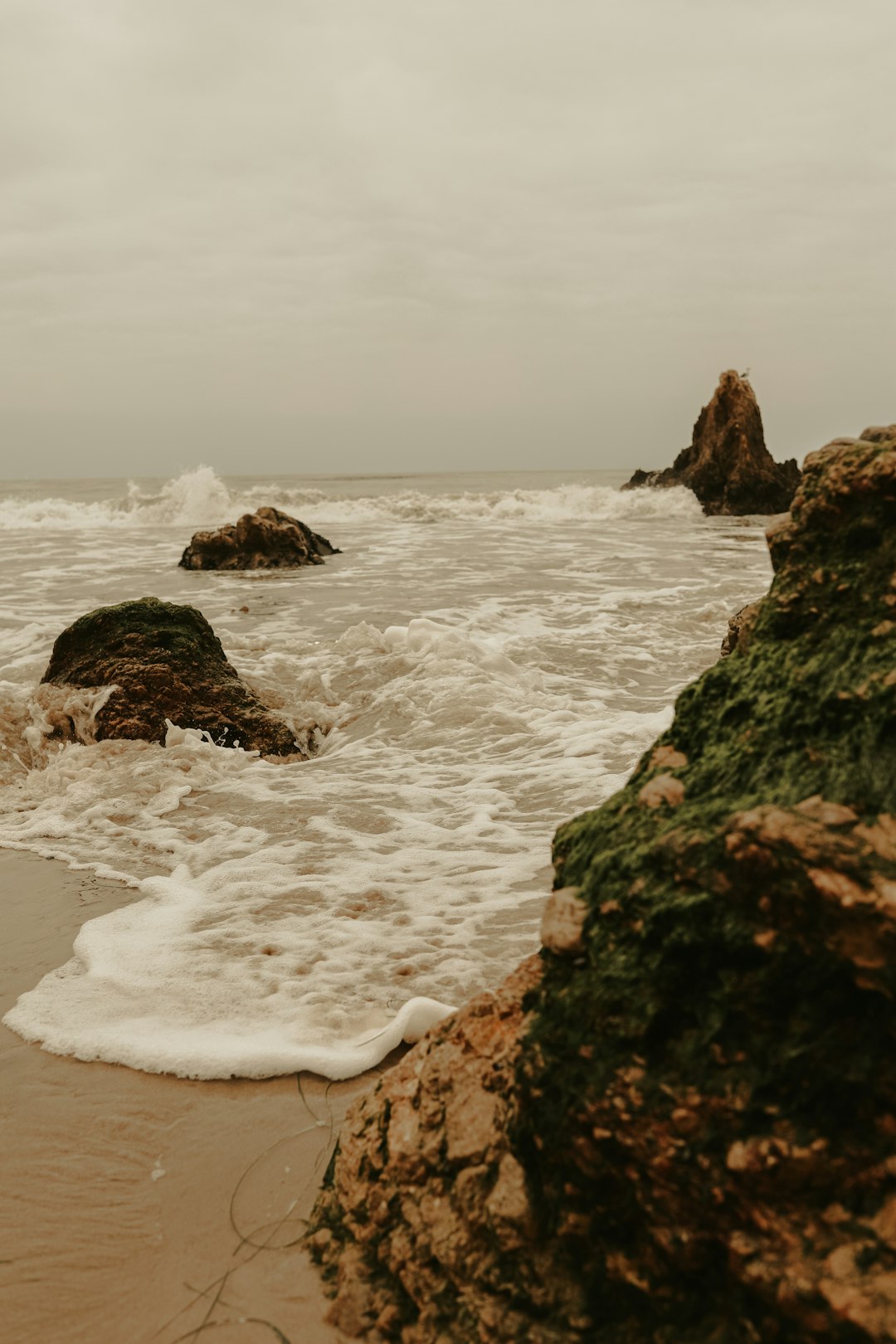 brown rock formation on sea shore during daytime