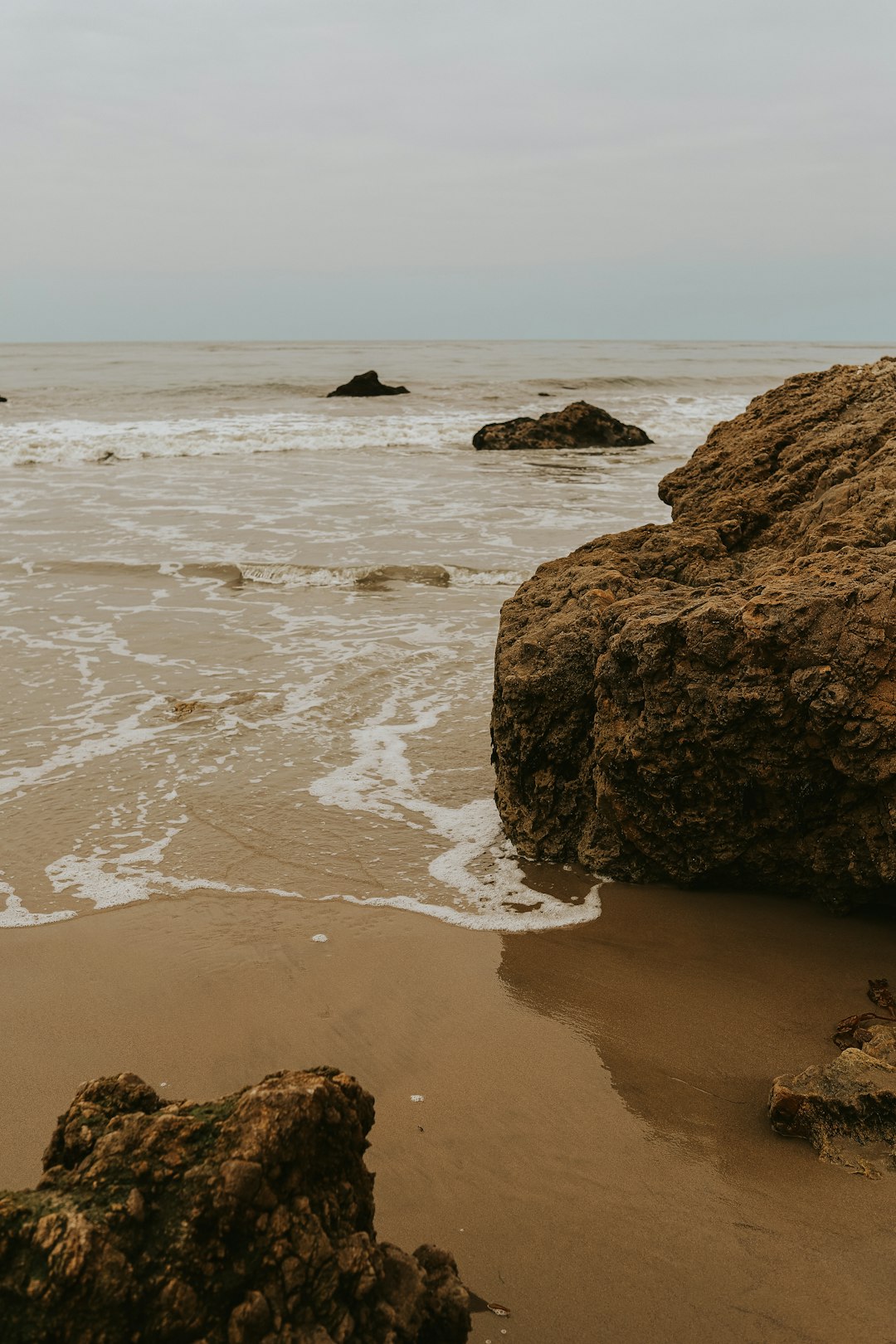 brown rock formation on sea shore during daytime