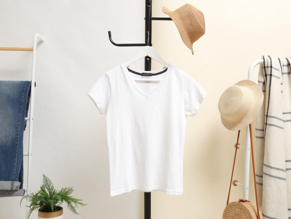 white crew neck t-shirt hanged on black clothes hanger