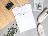 white crew neck shirt on white and green floral textile