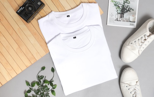 white crew neck shirt on white and green floral textile
