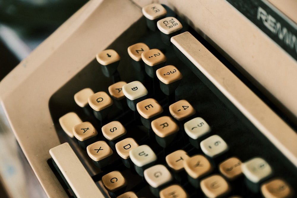 white and black typewriter on black table