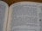 An open book with text on both visible pages. The focus is on the right page where the text is clear, showing paragraphs and numbered sections.
