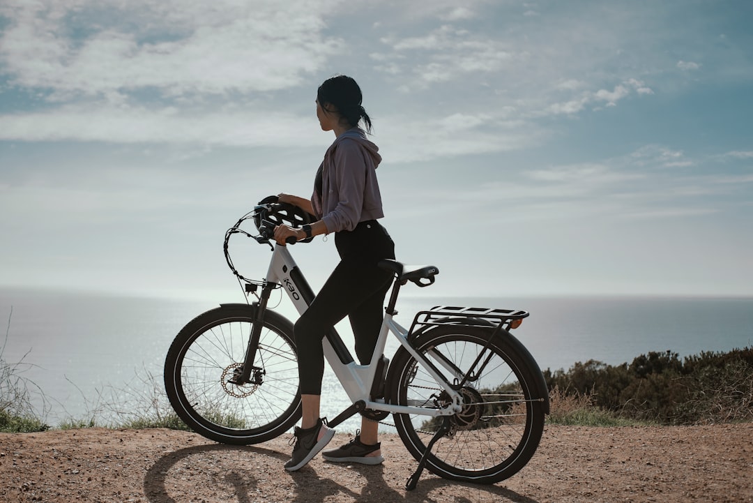 woman sitting on ebike water in background