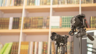A cozy room filled with books and a camera setup for recording an interview