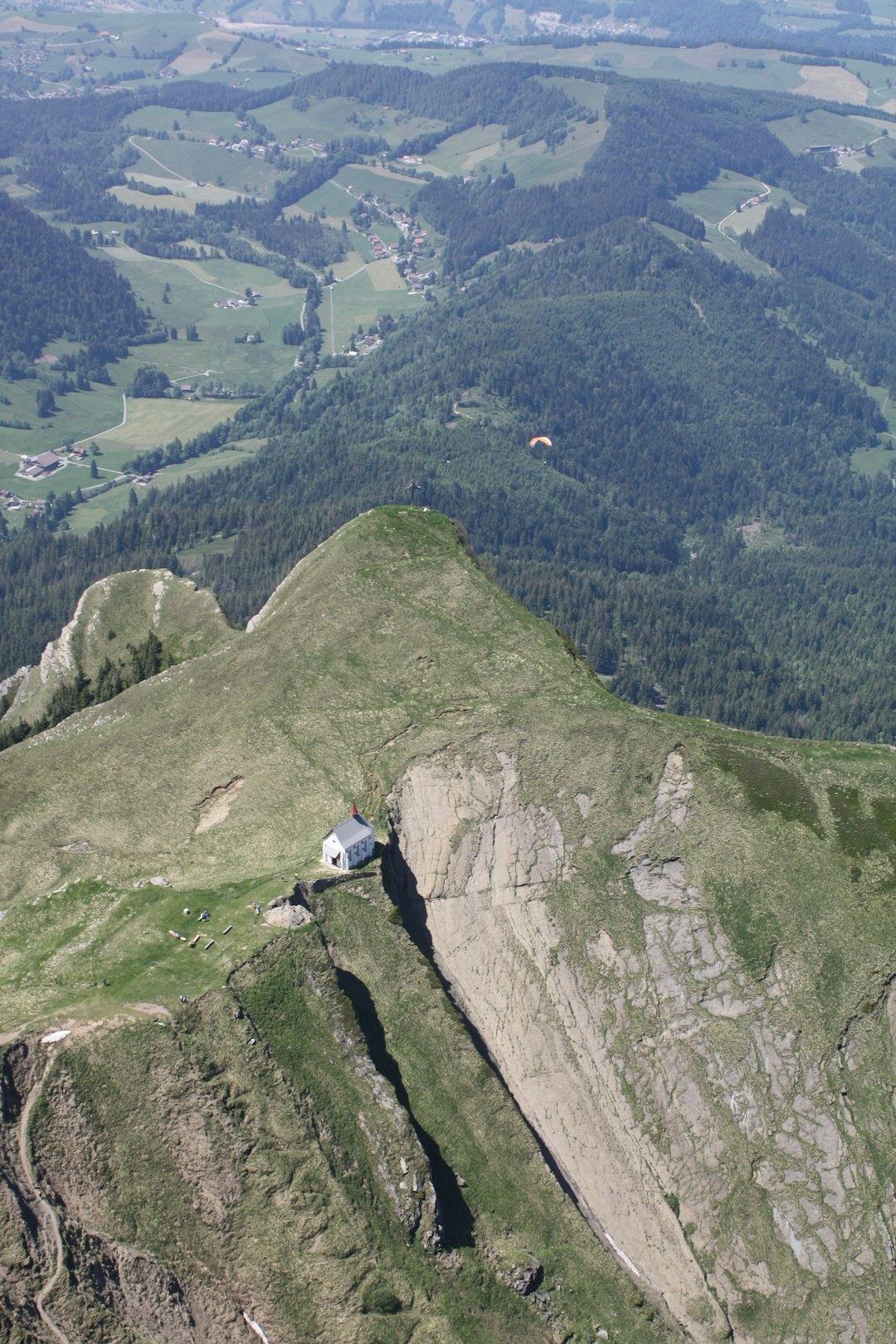 person in white shirt sitting on rock mountain during daytime