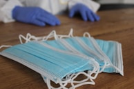 Disposable gloves, masks, and aprons laid out on a clean surface, highlighting hygiene supplies.