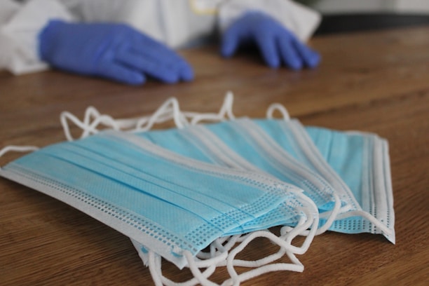 Close-up of comfysecure professional PPE gloves and masks neatly arranged on a clean surface.