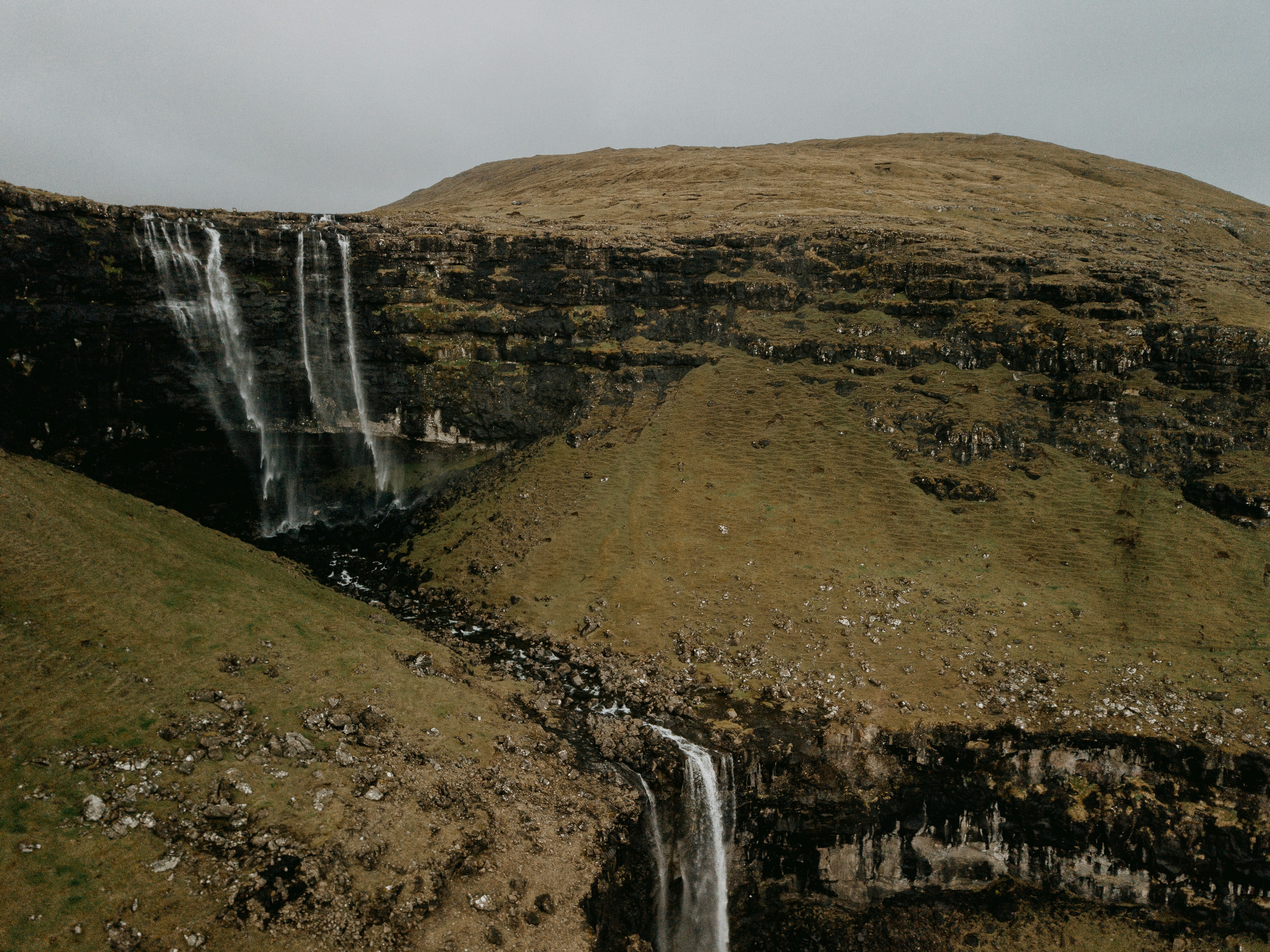 waterfalls on brown rocky mountain during daytime, 