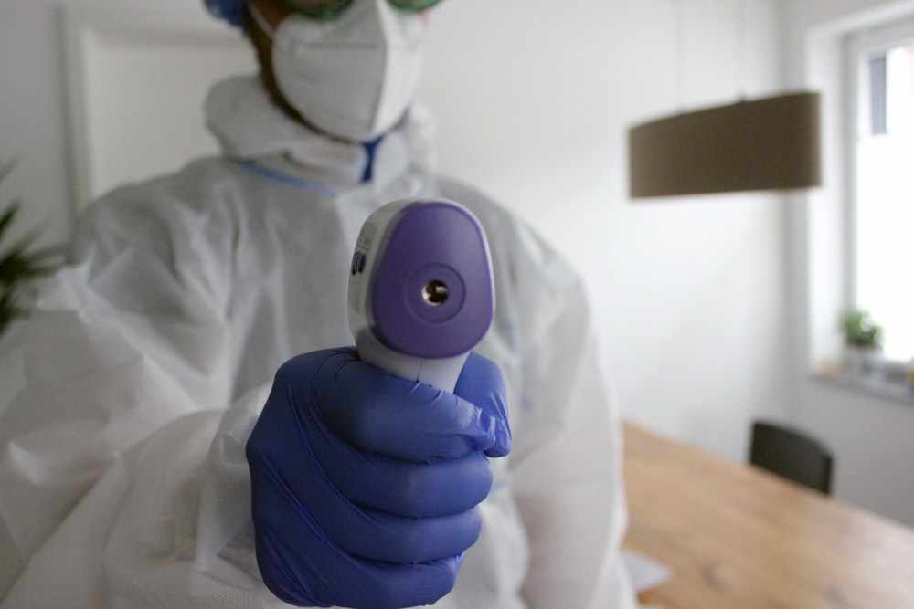 person in white long sleeve shirt wearing purple and white eye mask