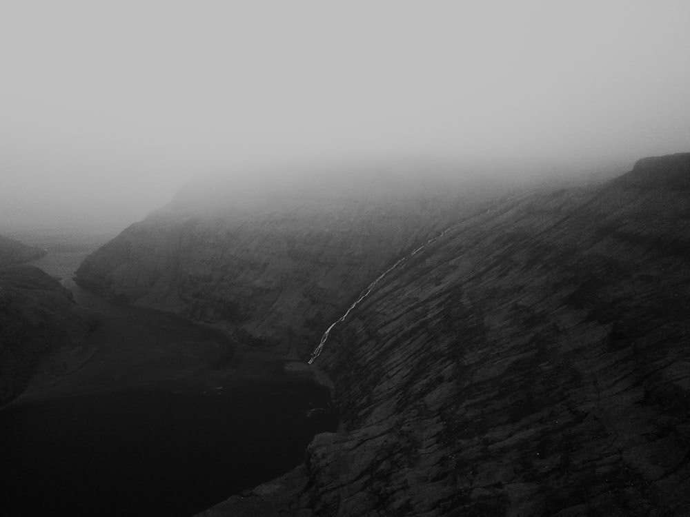 grayscale photo of mountains and river