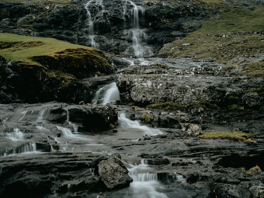 water falls on green grass field during daytime