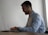 Close-up of a satisfied customer writing a positive review on a laptop.
