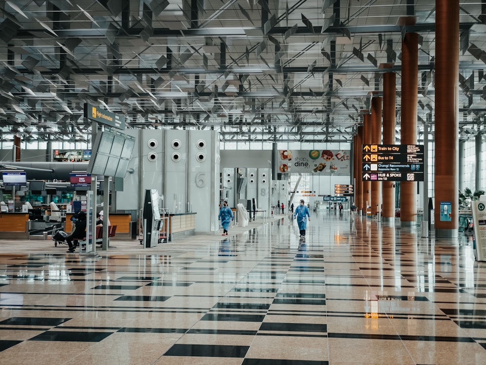 people walking on white and gray hallway