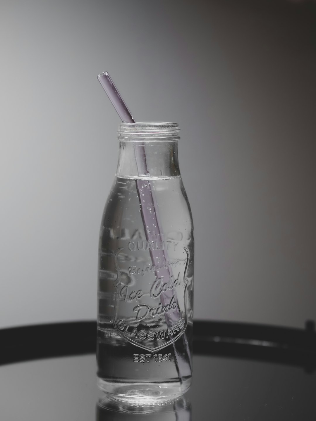 purple straw in clear glass jar