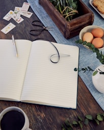 black framed eyeglasses on white notebook