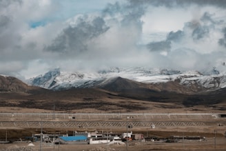 A futuristic Himalayan landscape with glowing quantum vaults nestled among snow-capped peaks.