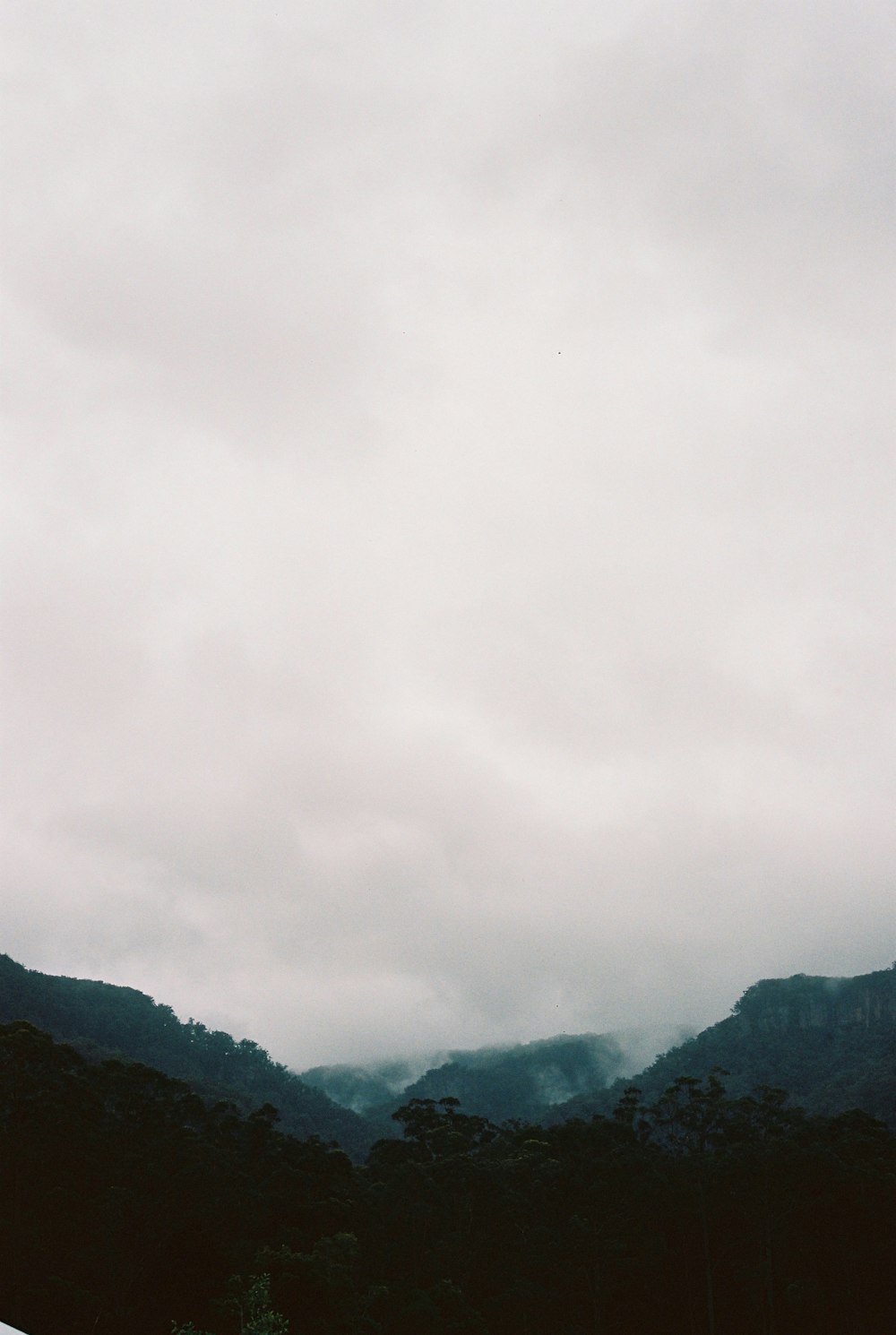 green mountains under white clouds during daytime