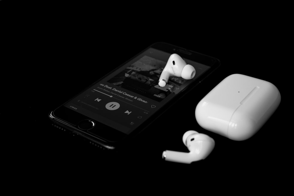 white earbuds on black iphone 4