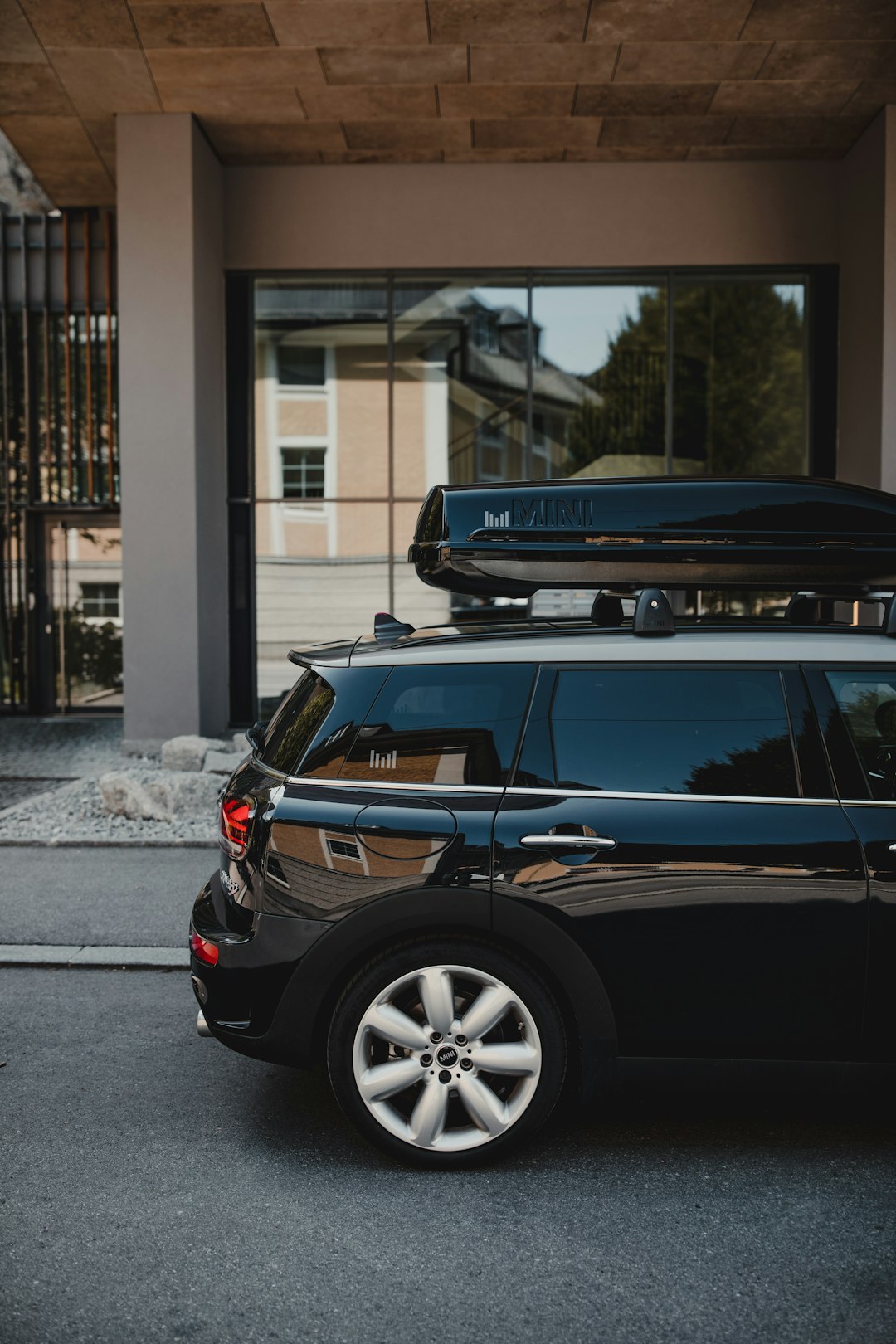 black suv with blue and white boat on top