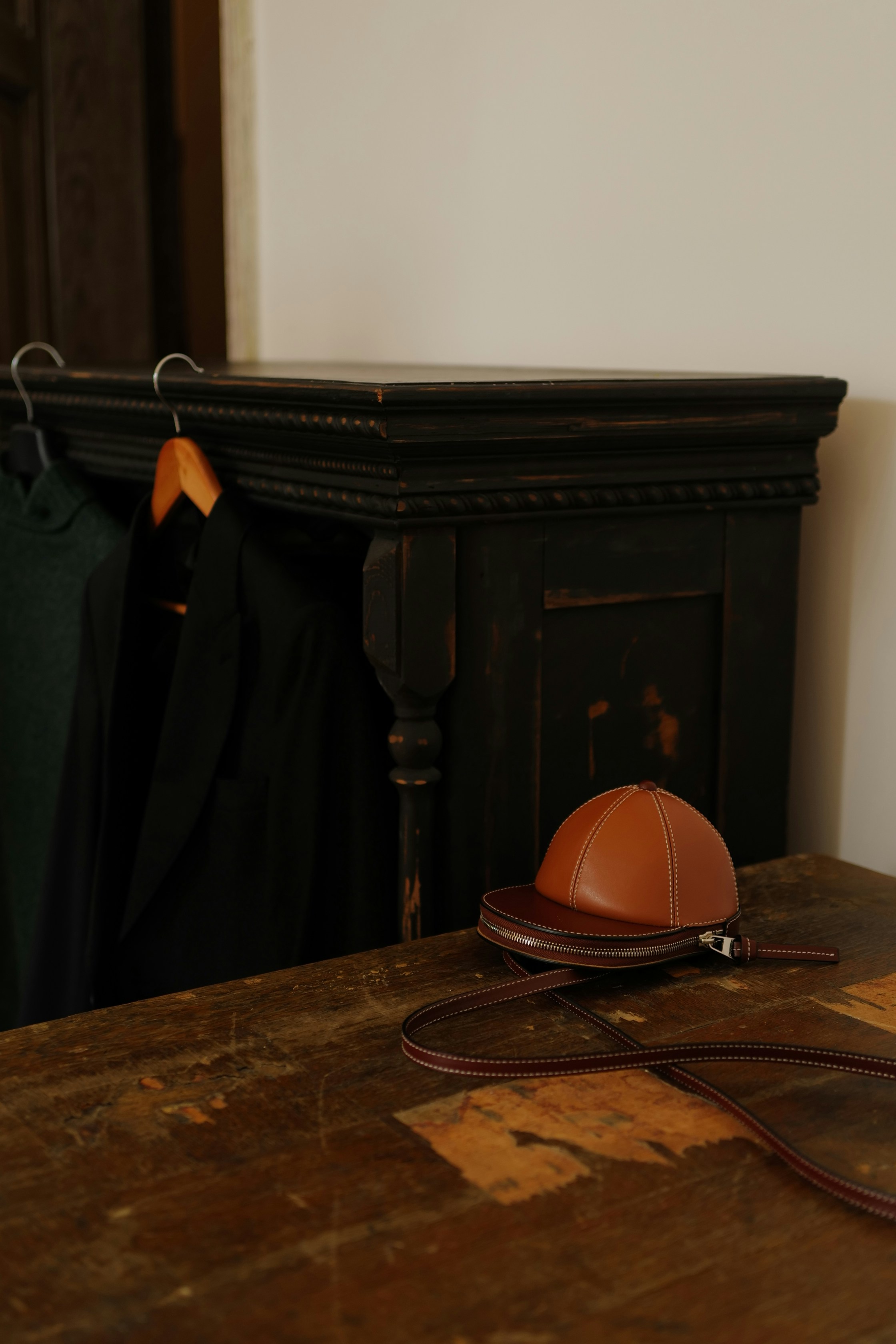brown leather bag on brown wooden table