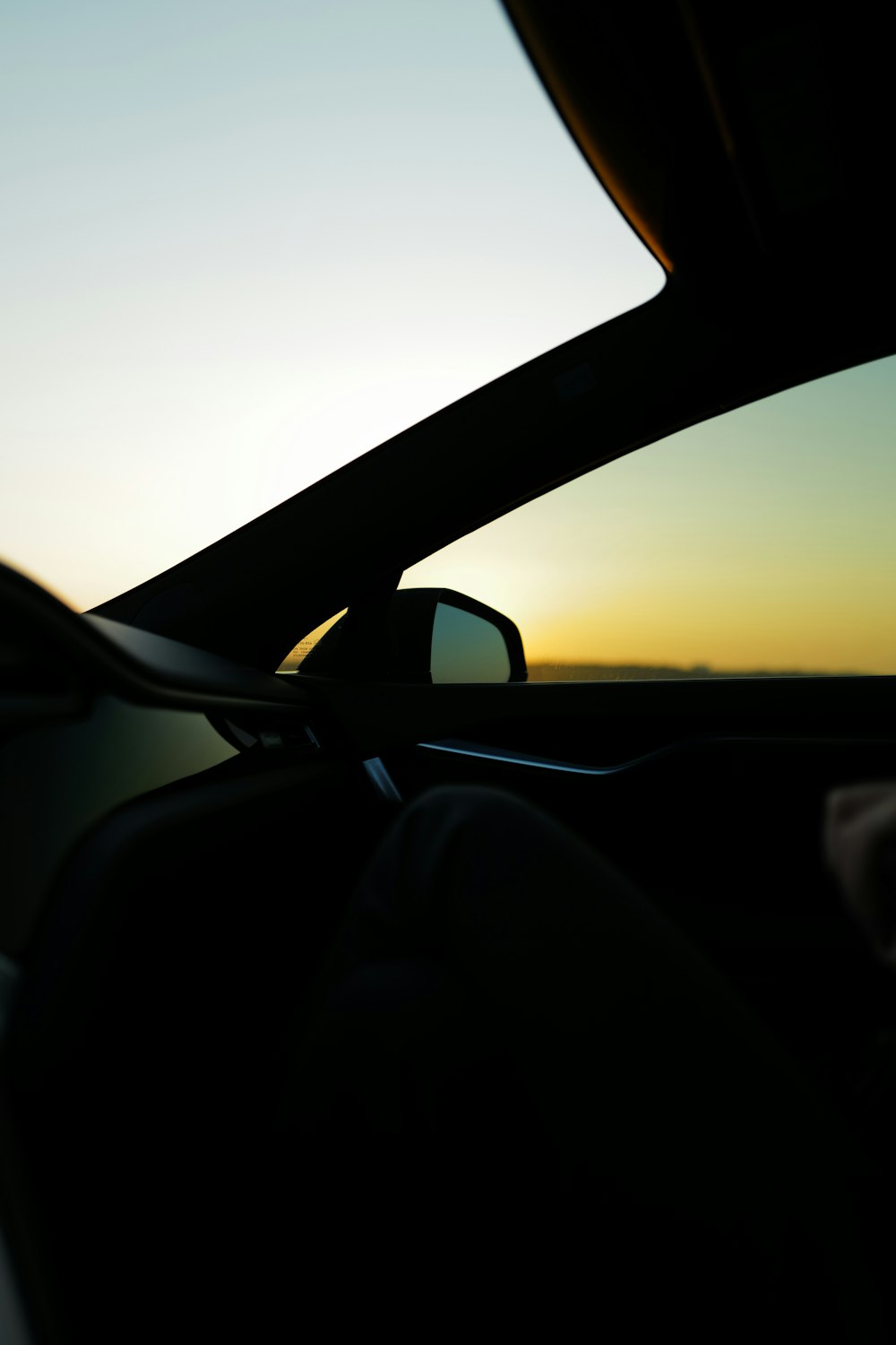 Schwarzer Autoseitenspiegel bei Sonnenuntergang