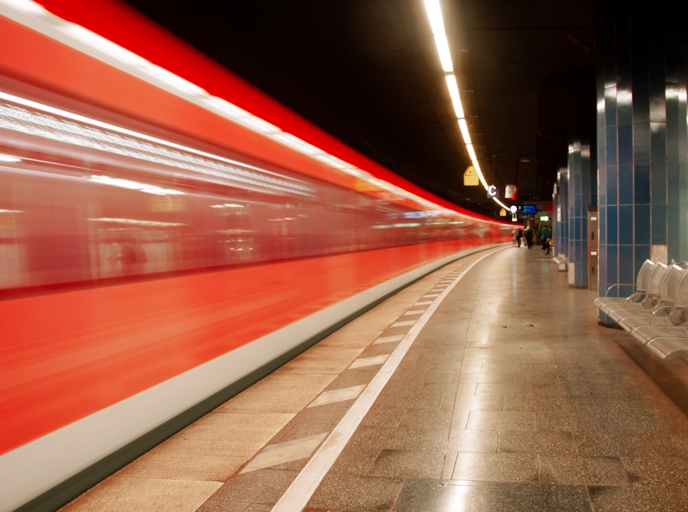 red and white train in a tunnel