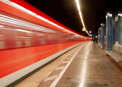 red and white train in a tunnel