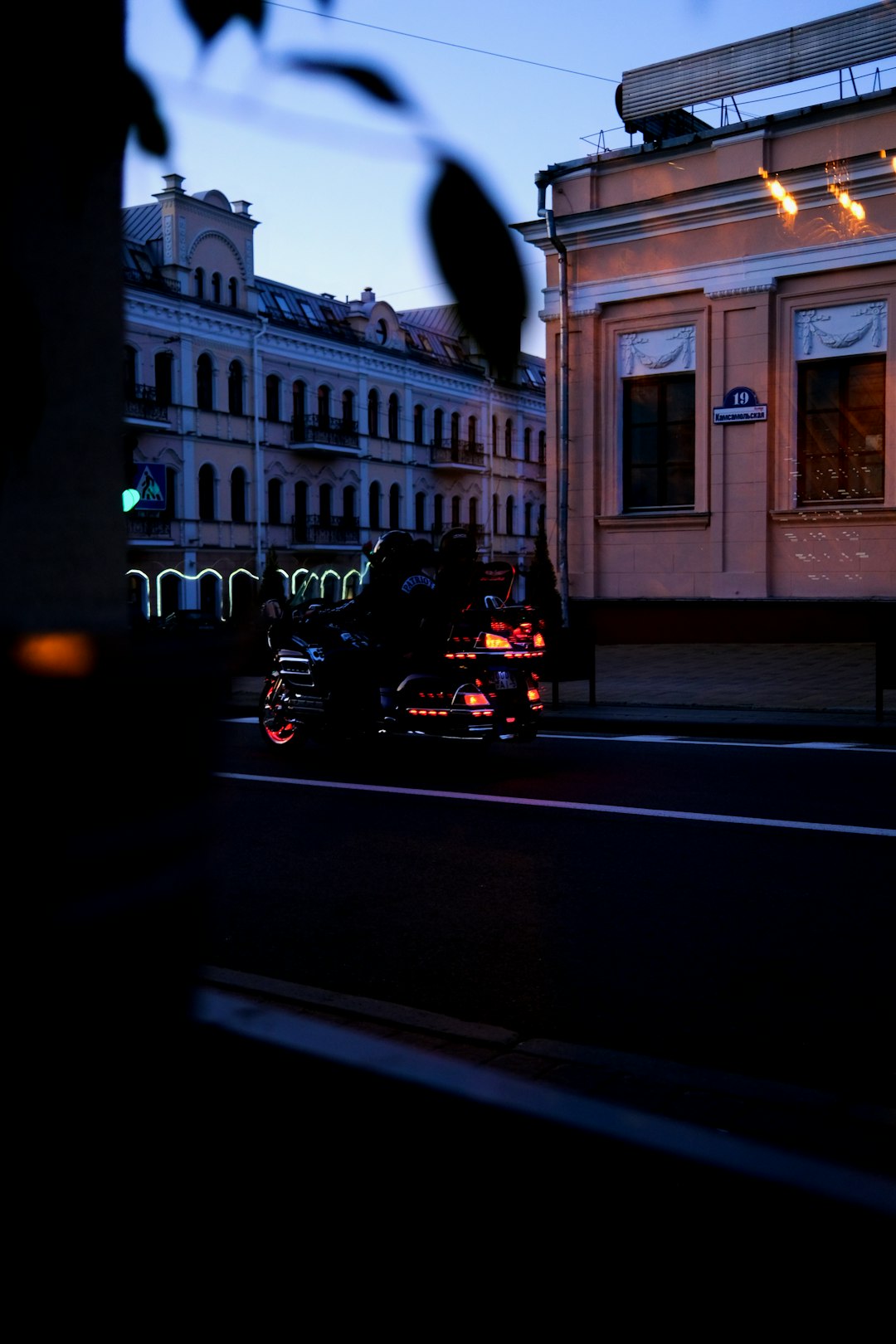 black car parked beside white building during night time