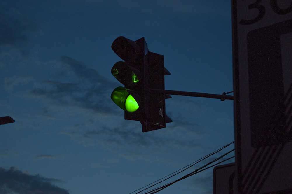 green traffic light under blue sky