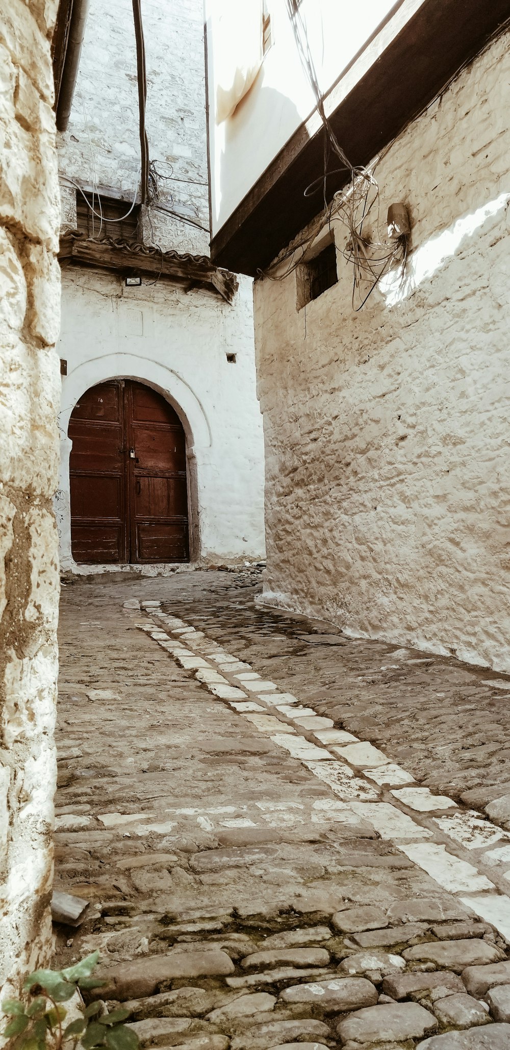 brown wooden door on gray concrete wall