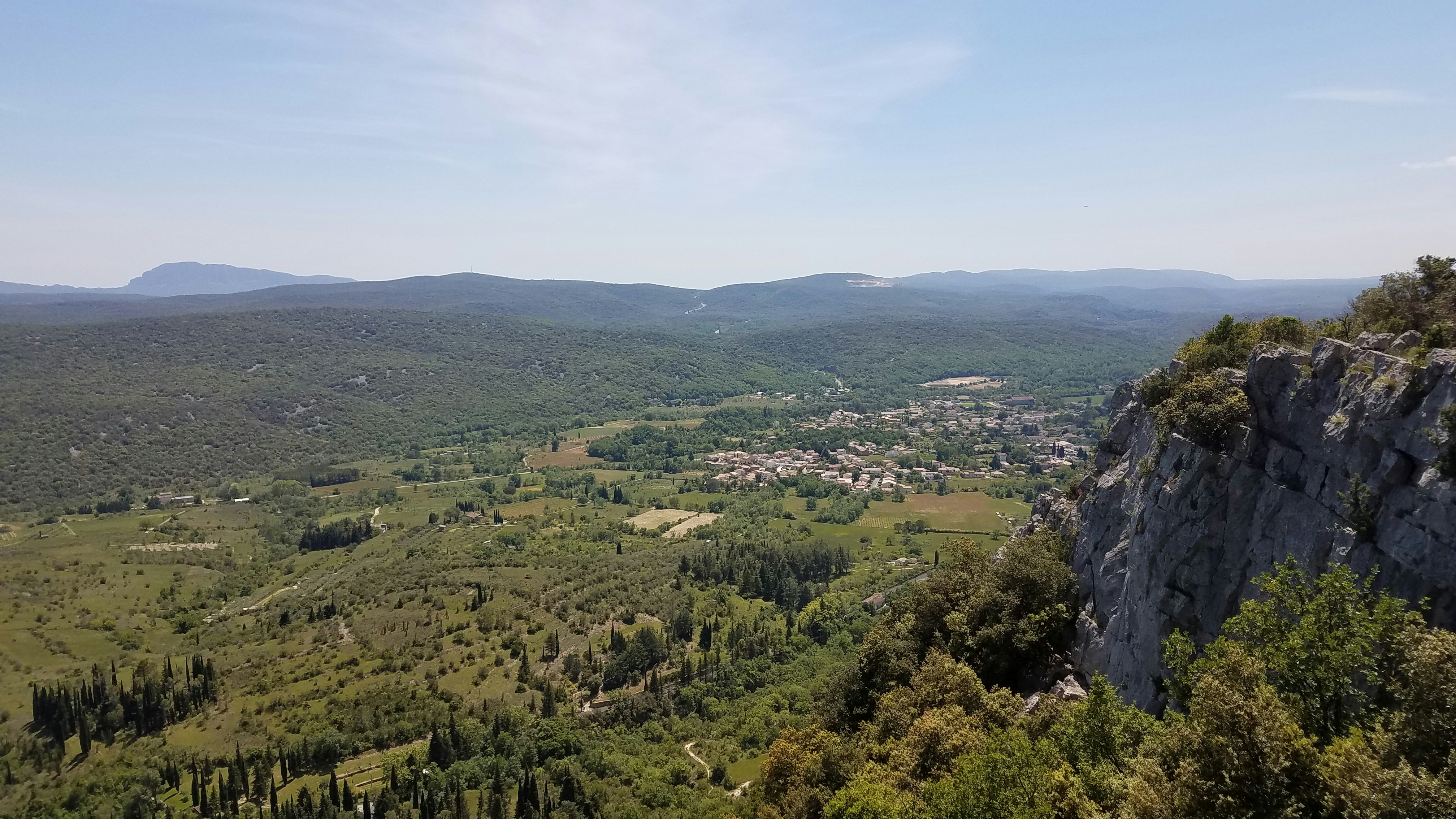 green trees on mountain under blue sky during daytime