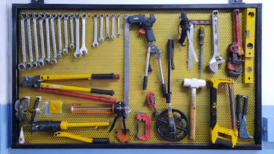 assorted hand tools on brown floor