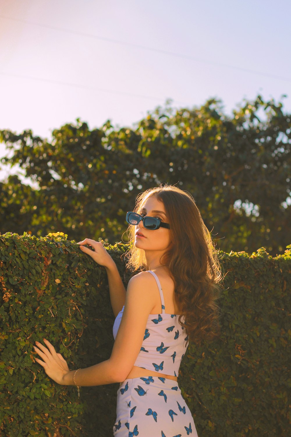 woman in white and black polka dot tank top wearing black sunglasses